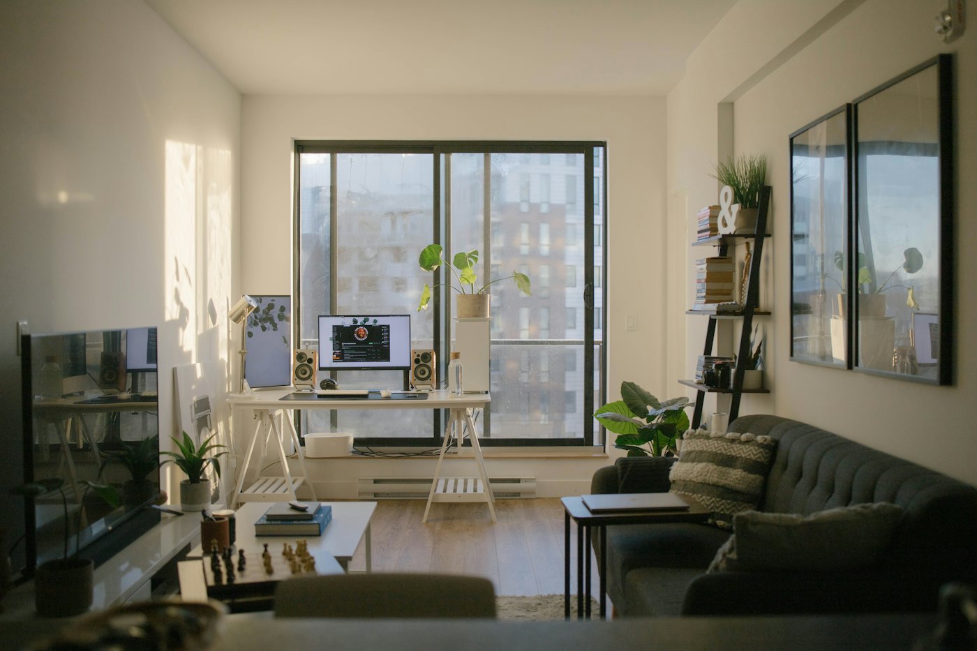 Sunlit apartment with a desk and workspace next to the living area